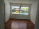Dining area featuring hardwood floors and pool view from the window at 2632 Derbyshire Rd, Maitland, FL 32751
