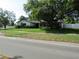 Home exterior with a large tree in the front yard at 2632 Derbyshire Rd, Maitland, FL 32751