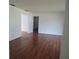 Hardwood-floored living room with neutral walls and trim at 2632 Derbyshire Rd, Maitland, FL 32751