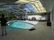 Enclosed pool area featuring a cool blue swimming pool and a shaded area, perfect for relaxation at 2632 Derbyshire Rd, Maitland, FL 32751