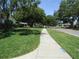 Street view with tree lined street and sidewalks at 2632 Derbyshire Rd, Maitland, FL 32751