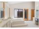Elegant bathroom featuring a soaking tub, large window and modern fixtures, designed for relaxation at 2652 Bent Hickory Cir, Longwood, FL 32779