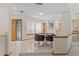 Dining area with open access to the main entrance hall featuring large windows and elegant finishes at 2652 Bent Hickory Cir, Longwood, FL 32779