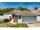Charming single-story home featuring a two-car garage, mature trees, and a well-maintained front yard at 2652 Bent Hickory Cir, Longwood, FL 32779