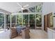 Enjoy the screened patio with tile flooring, ceiling fan, and lush backyard views at 2652 Bent Hickory Cir, Longwood, FL 32779