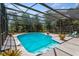 Beautiful screened-in pool is surrounded by lush greenery, offering privacy and relaxation at 2652 Bent Hickory Cir, Longwood, FL 32779