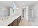 Modern bathroom featuring double sinks, quartz countertop, and glass enclosed shower at 2659 Fiddle Leaf Loop, Apopka, FL 32712