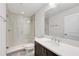 Well-lit bathroom featuring a large mirror, sleek vanity, and a modern glass-enclosed shower at 2659 Fiddle Leaf Loop, Apopka, FL 32712