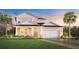 Inviting two-story home featuring a well-manicured lawn, attached two-car garage, and craftsman-style accents at 2659 Fiddle Leaf Loop, Apopka, FL 32712