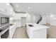 Bright, modern kitchen with white cabinetry, stainless steel appliances, and a large island at 2659 Fiddle Leaf Loop, Apopka, FL 32712