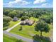 Expansive property featuring a house, guest house, and long driveway on a well-manicured lawn with mature trees at 2659 Hibbard Trl, Chuluota, FL 32766