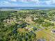 A property with defined property lines, lush greenery and mature trees are seen from an aerial view at 2659 Hibbard Trl, Chuluota, FL 32766