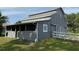 Gray barn featuring horse stalls with metal mesh windows, offering a safe and secure environment at 2659 Hibbard Trl, Chuluota, FL 32766
