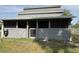 Gray barn featuring horse stalls with metal mesh windows, offering a safe and secure environment at 2659 Hibbard Trl, Chuluota, FL 32766