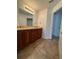 Bathroom featuring a double vanity and door leading to the tiled shower at 2659 Hibbard Trl, Chuluota, FL 32766