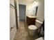 Comfortable bathroom featuring tile floors, wood vanity, and a well-lit mirror above the sink at 2659 Hibbard Trl, Chuluota, FL 32766