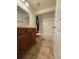 Bright bathroom featuring a bathtub with white tiled walls, wood vanity, and tile flooring at 2659 Hibbard Trl, Chuluota, FL 32766