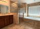 Bathroom featuring soaking tub, stand up shower, and a vanity sink at 2659 Hibbard Trl, Chuluota, FL 32766