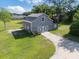 Detached garage exterior with a white crossbuck door, providing a rustic and charming curb appeal at 2659 Hibbard Trl, Chuluota, FL 32766