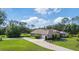 Beautiful home with a well-manicured lawn and a long driveway leading to the attached garage at 2659 Hibbard Trl, Chuluota, FL 32766