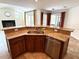 Kitchen island featuring a stainless steel sink, dishwasher, and seating space, with a pool view at 2659 Hibbard Trl, Chuluota, FL 32766