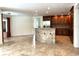 Open-concept kitchen with stainless steel appliances, granite countertops, and an island bar area at 2659 Hibbard Trl, Chuluota, FL 32766