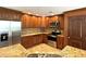 Kitchen boasting wood cabinets, stainless steel appliances, granite countertops, and tile backsplash at 2659 Hibbard Trl, Chuluota, FL 32766