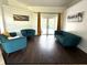 Bright living room boasts stylish furniture and a view of the pool from the French doors at 2659 Hibbard Trl, Chuluota, FL 32766