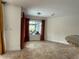 Living room with tile flooring and a window overlooking a patio area at 2659 Hibbard Trl, Chuluota, FL 32766