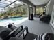 Screened-in pool with waterfall feature, surrounded by lush landscaping, offers a private oasis at 2659 Hibbard Trl, Chuluota, FL 32766