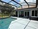 Relax by the pool in the screened enclosure with lovely patio furniture and lush landscaping at 2659 Hibbard Trl, Chuluota, FL 32766