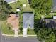 Aerial shot showcases the property with a manicured lawn, mature trees, and a neighborhood setting at 2710 Autumn Ln, Eustis, FL 32726