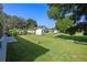 Serene backyard featuring a spacious lawn, storage shed, and peaceful surroundings at 2710 Autumn Ln, Eustis, FL 32726