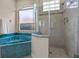 Bathroom with glass shower, bathtub, tile flooring, and neutral colors at 2710 Autumn Ln, Eustis, FL 32726