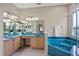 Bathroom featuring a large mirror, double sinks, tub, and tiled floors at 2710 Autumn Ln, Eustis, FL 32726