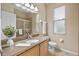 Bathroom featuring a large mirror, granite countertops, and a tiled shower at 2710 Autumn Ln, Eustis, FL 32726