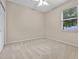 Cozy bedroom with carpeted floors and a window at 2710 Autumn Ln, Eustis, FL 32726
