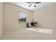 Bright bedroom with ceiling fan, window view and a desk area at 2710 Autumn Ln, Eustis, FL 32726