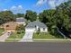 Charming home with a well-manicured front lawn and driveway, nestled among mature trees at 2710 Autumn Ln, Eustis, FL 32726