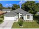 Charming single-story home featuring a well-manicured lawn and attached two-car garage at 2710 Autumn Ln, Eustis, FL 32726