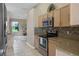 This kitchen features wooden cabinets, stainless steel appliances, and granite countertops at 2710 Autumn Ln, Eustis, FL 32726