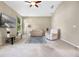 Bright living room featuring neutral walls, a ceiling fan, and plush seating at 2710 Autumn Ln, Eustis, FL 32726