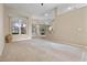 Open-concept living area with plush carpeting and seamless transition to the dining area at 2710 Autumn Ln, Eustis, FL 32726