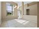 Bright and airy living room with tile floors, large windows, and elegant lighting fixtures at 2710 Autumn Ln, Eustis, FL 32726