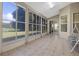 Enclosed patio featuring tile floors, a seating area, and large windows at 2710 Autumn Ln, Eustis, FL 32726