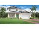 Beautiful two-story home featuring a manicured lawn, two-car garage, and well-maintained landscaping at 2772 Golden Barrel A Ave, Apopka, FL 32712