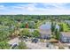 Aerial view showcases the community's pond, mature trees, and assigned parking at 283 Woodgreen Ln, Winter Springs, FL 32708