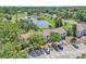 An aerial view of the community with a pond and mature trees at 283 Woodgreen Ln, Winter Springs, FL 32708