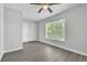 Bright bedroom features wood-look floors, a window, and a ceiling fan at 283 Woodgreen Ln, Winter Springs, FL 32708