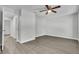 Spacious bedroom offers ample natural light, a ceiling fan, and modern wood-look flooring at 283 Woodgreen Ln, Winter Springs, FL 32708
